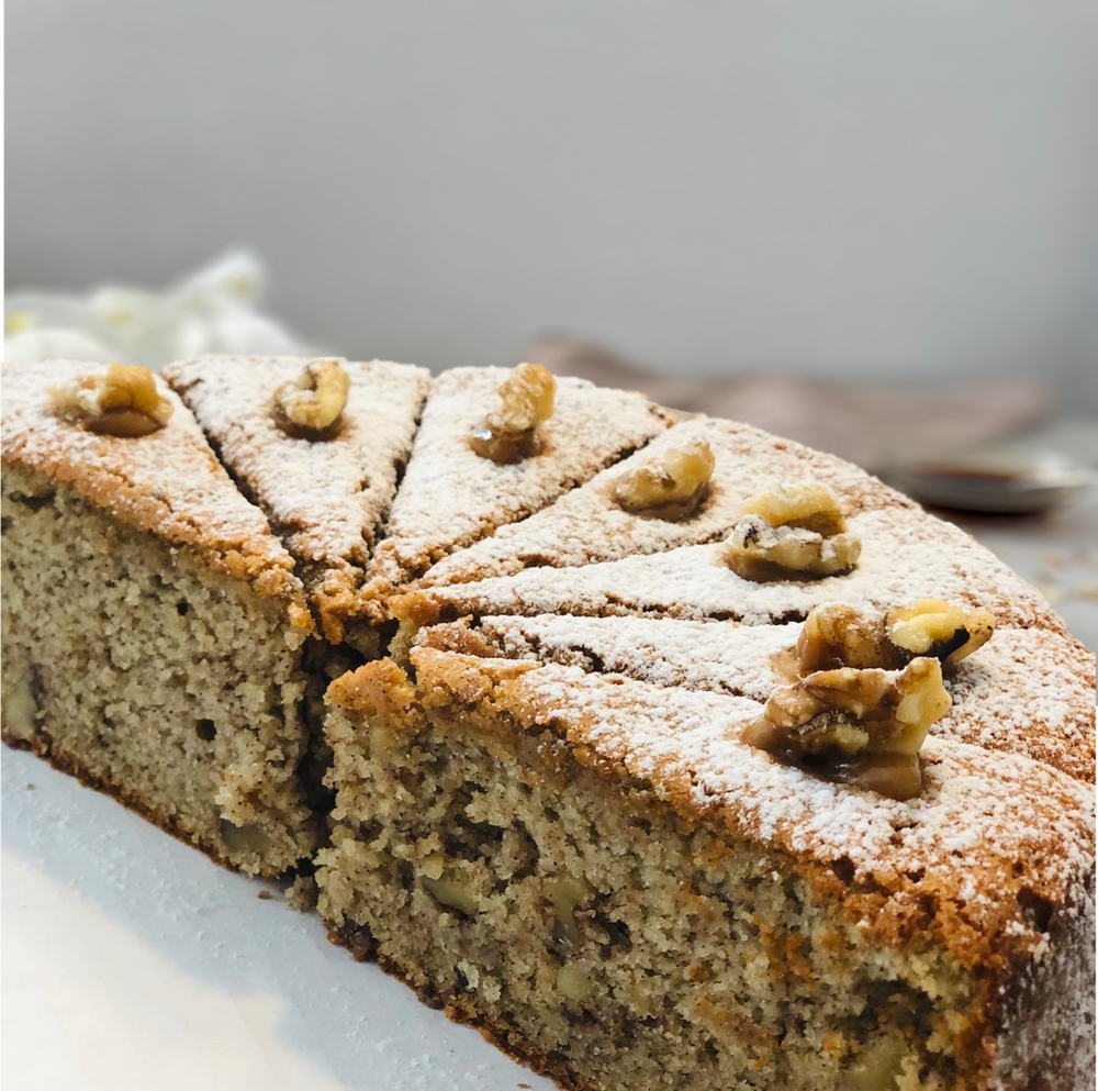 Gluten-free, sugar-free, dairy-free Banana Walnut Full Life Cake with caramel drizzle and crunchy walnuts, emphasizing its moist texture and rich banana flavor. Full Life Gourmet Bakery