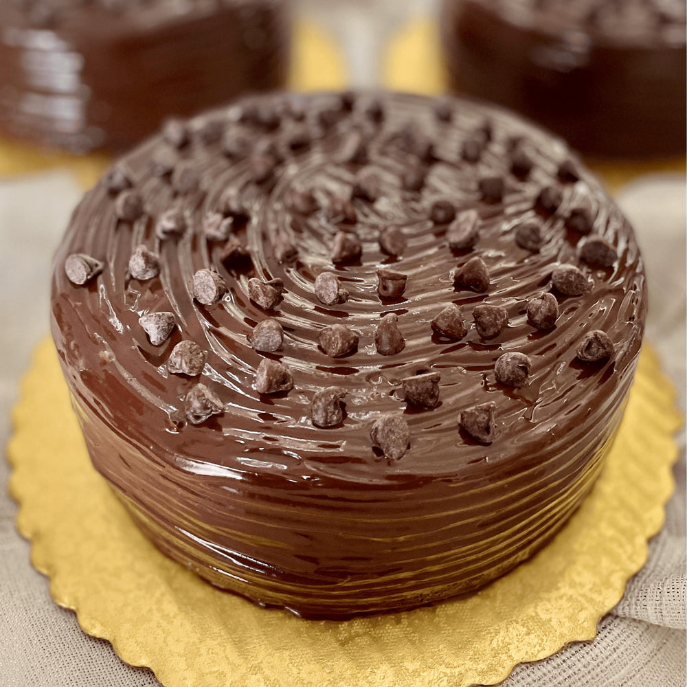 
                  
                    Gluten-free, sugar-free, dairy-free Chocolate Lovers Full Life cake with organic dark chocolate and sugar-free chocolate chips, topped with sugar-free chocolate syrup, offering a rich and moist texture. Full Life Gourmet Bakery
                  
                