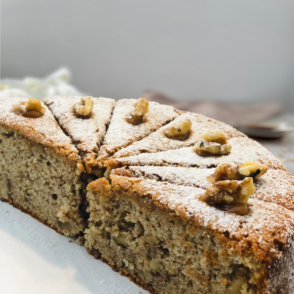
                  
                    Gluten-free, sugar-free, dairy-free Banana Walnut Full Life Cake with caramel drizzle and crunchy walnuts, emphasizing its moist texture and rich banana flavor. Full Life Gourmet Bakery
                  
                