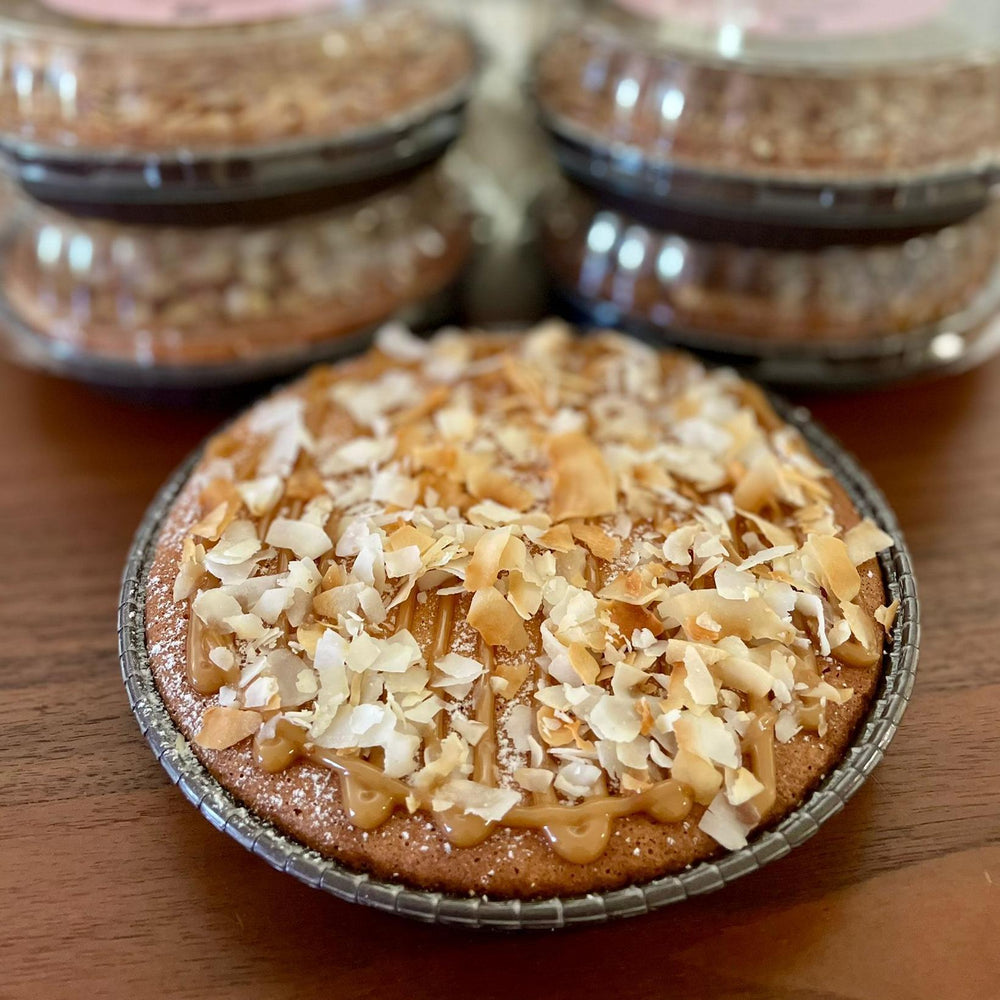 
                  
                    Gluten-free, sugar-free, dairy-free Coconut Full Life Cake topped with sugar-free caramel syrup and golden brown toasted coconut flakes, offering a taste of tropical indulgence.Full Life Gourmet Bakery
                  
                