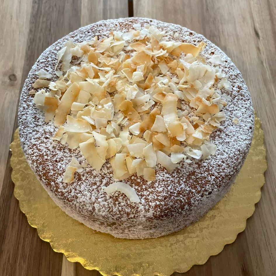 
                  
                    Gluten-free, sugar-free, dairy-free Coconut Full Life Cake topped with sugar-free caramel syrup and golden brown toasted coconut flakes, offering a taste of tropical indulgence.Full Life Gourmet Bakery
                  
                
