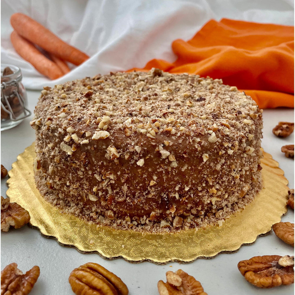 Gluten-free, sugar-free, dairy-free Carrot Pecan Full Life Cake topped with sugar-free caramel syrup and toasted chopped pecans, featuring sweet organic carrots and rich cinnamon for a moist, delicious slice.Full Life Gourmet Bakery
