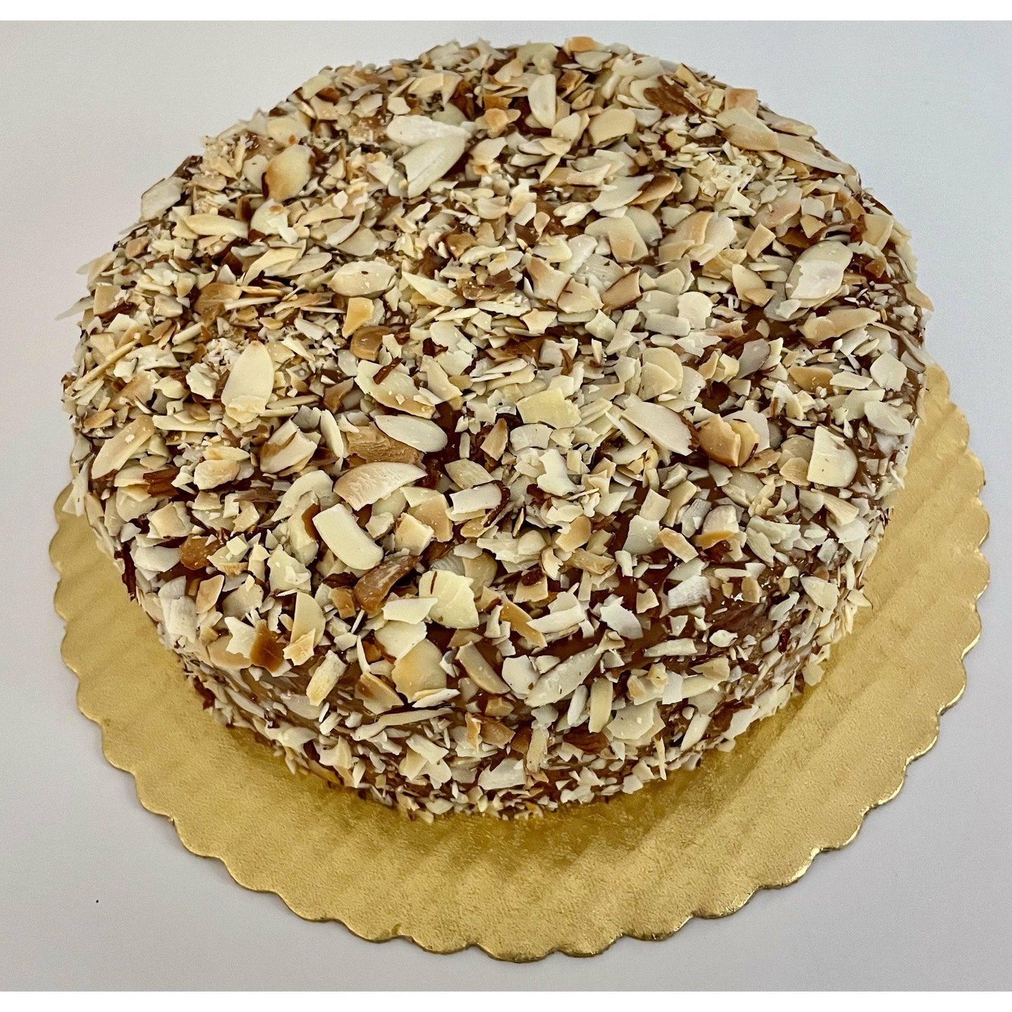 
                  
                    Gluten-free, dairy-free, sugar-free Lemon Lush Cake topped with sugar-free caramel syrup and toasted almonds, highlighting its fluffy texture and zesty lemon flavor. Full Life Gourmet Bakery
                  
                