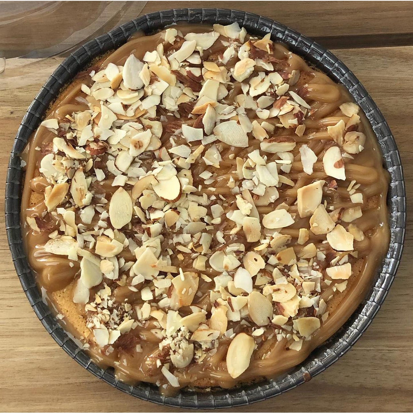 
                  
                    Gluten-free, dairy-free, sugar-free Lemon Lush Cake topped with sugar-free caramel syrup and toasted almonds, highlighting its fluffy texture and zesty lemon flavor. Full Life Gourmet Bakery
                  
                