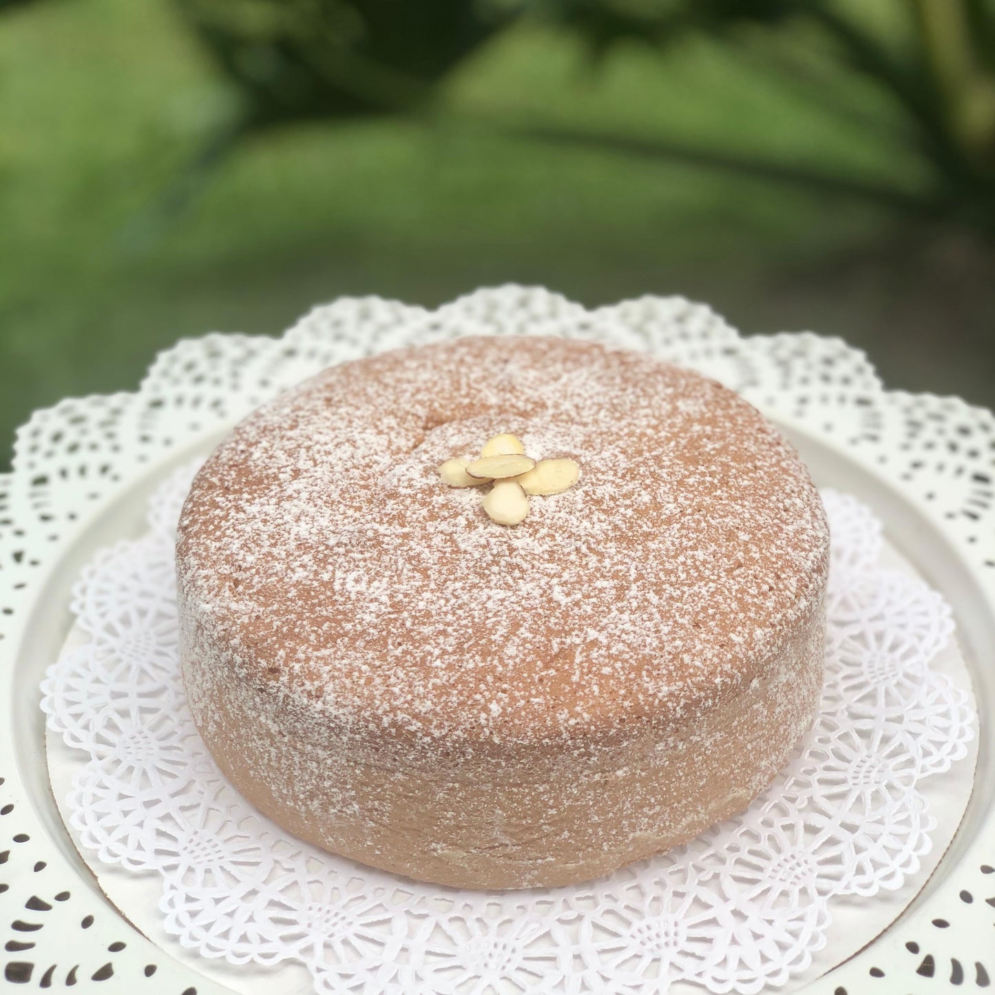 
                  
                    Gluten-free, dairy-free, sugar-free Lemon Lush Cake topped with sugar-free caramel syrup and toasted almonds, highlighting its fluffy texture and zesty lemon flavor. Full Life Gourmet Bakery
                  
                