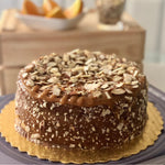Tangy Florida Orange cake with caramel waterfall and toasted almond topping, a citrusy, sugar, dairy and gluten-free treat. Full Life Gourmet Bakery