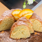 Tangy Florida Orange cake with caramel waterfall and toasted almond topping, a citrusy, sugar, dairy and gluten-free treat. Full Life Gourmet Bakery