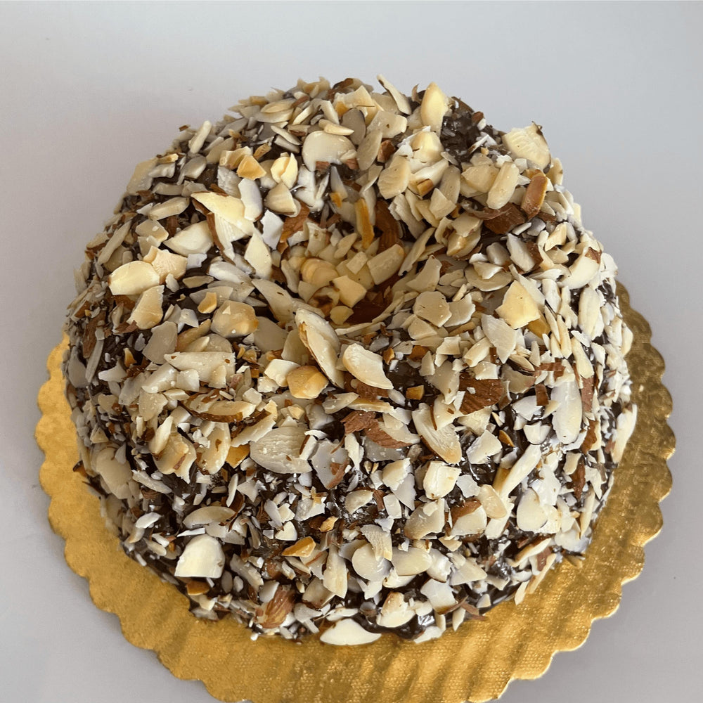 Gluten-free, dairy-free, sugar-free Vanilla and Chocolate, Marvelous Marble Full Life cake, featuring layers of moist vanilla and rich dark chocolate, topped with sugar-free chocolate syrup and extra chocolate chips for a luxurious finish. Full Life Gourmet Bakery