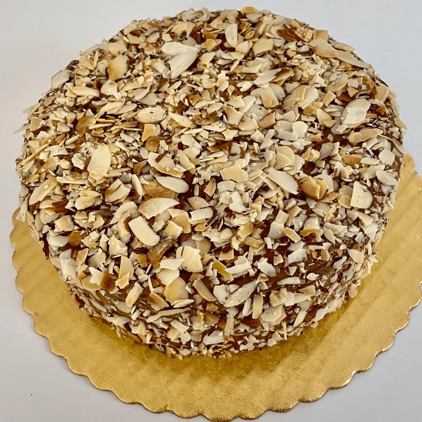 
                  
                    Gluten-free, dairy-free, sugar-free Vanilla Caramel Full Life Cake with a sugar-free caramel syrup drizzle and toasted almonds, showcasing its spongy texture and rich vanilla aroma. Full Life Gourmet Bakery
                  
                